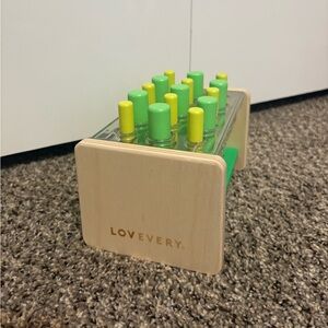 Lovevery Wooden Posting Stand with Green and Yellow Pegs